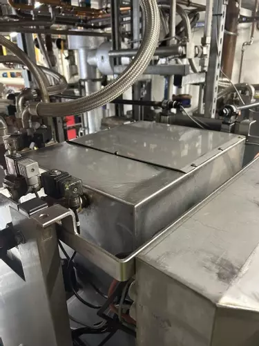 Top view of custom stainless steel replacement tank installed on a Nilfisk Delta Booster multi-pump pressure washer system.